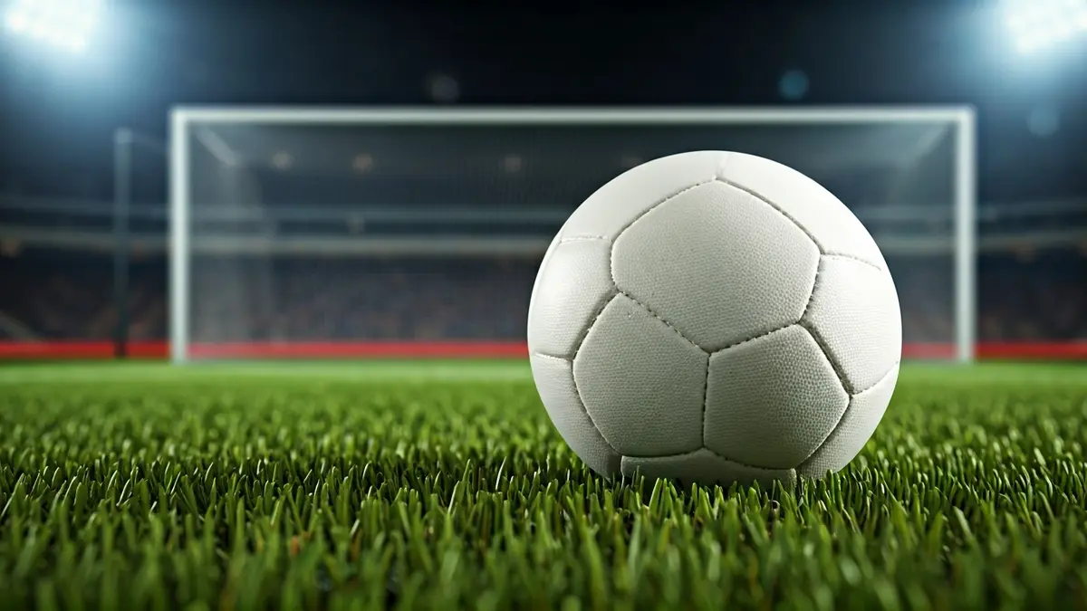 Generic image of a soccer ball on a stadium pitch.