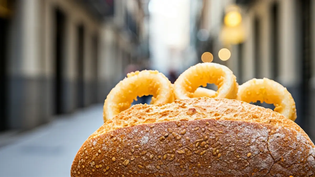 Imagen de un bocadillo de calamares recién hecho en un pan crujiente.