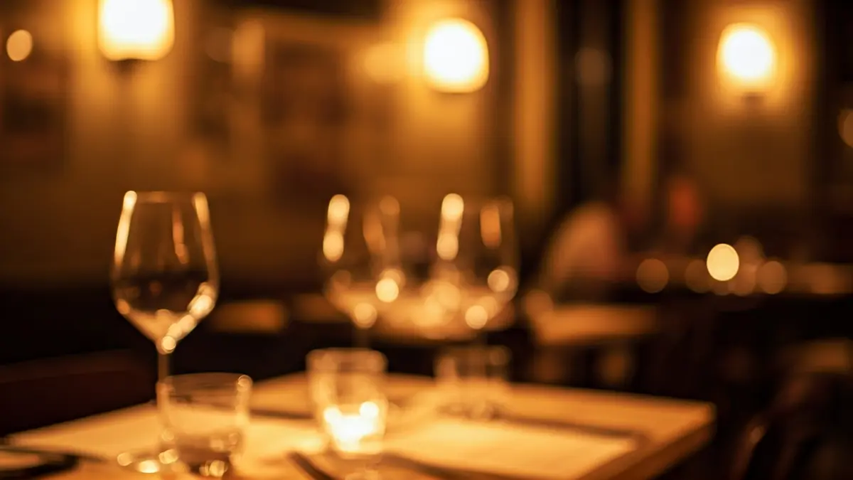 Generic image of a restaurant with tables set for dinner, wine glasses, and a cozy atmosphere.