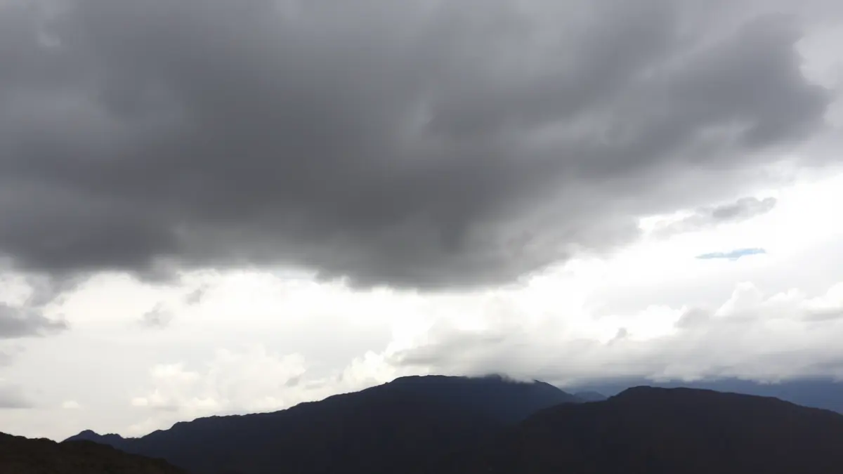 Generic image of a cloudy sky with a possibility of dry thunderstorms over a mountainous landscape.