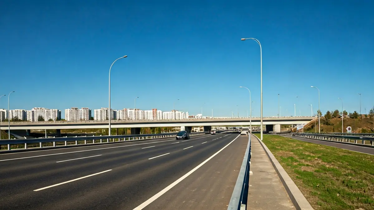 Image of a renovated pedestrian bridge over a highway, with wide sidewalks and modern lighting.
