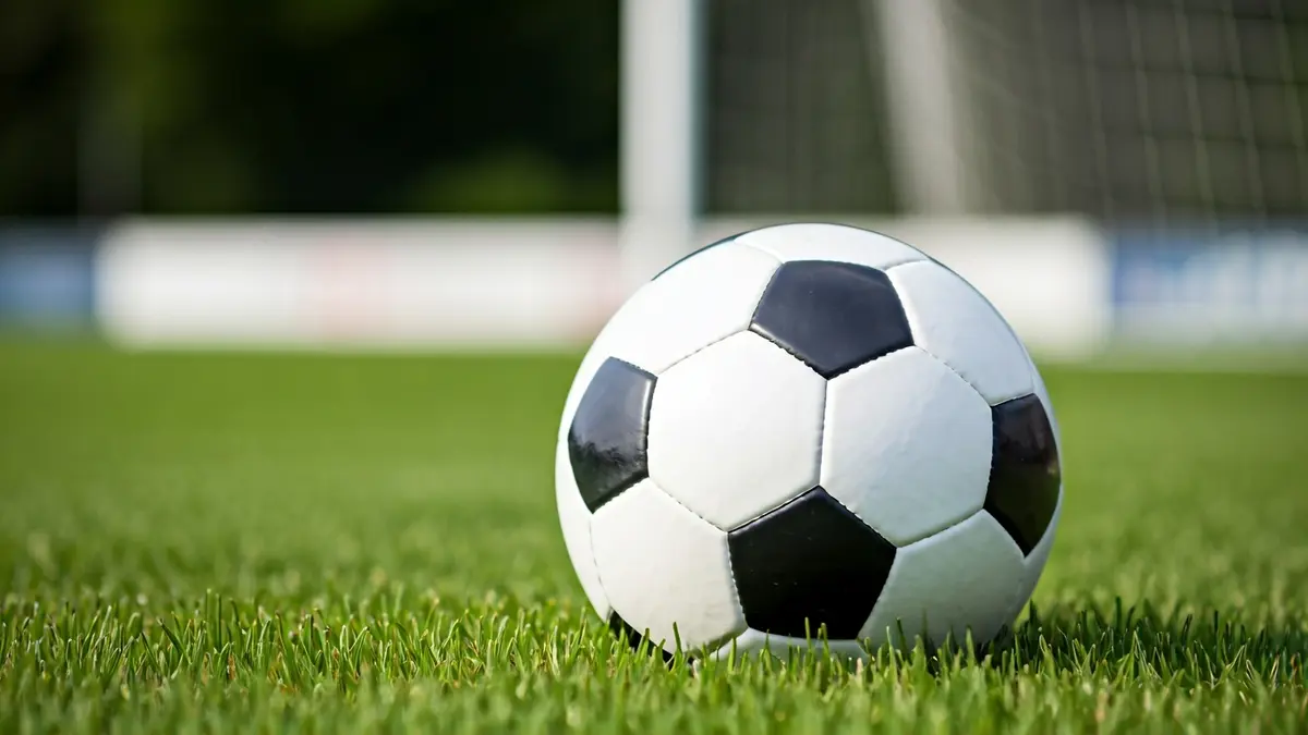 Generic image of a soccer ball on a grass field.