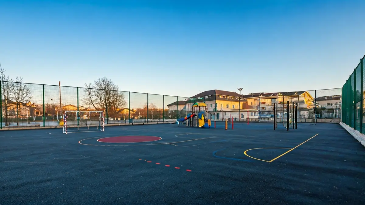 Generic image of an empty school playground with sports equipment.
