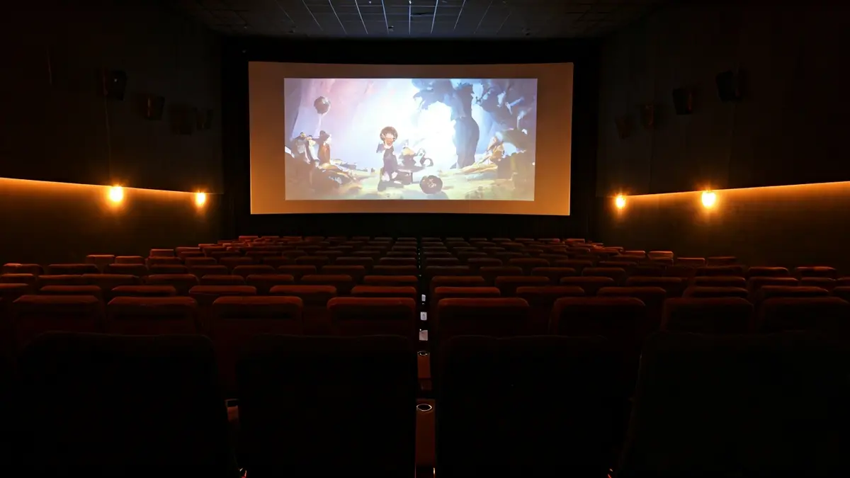 Generic image of a cinema with empty seats and a screen projecting an animated film.