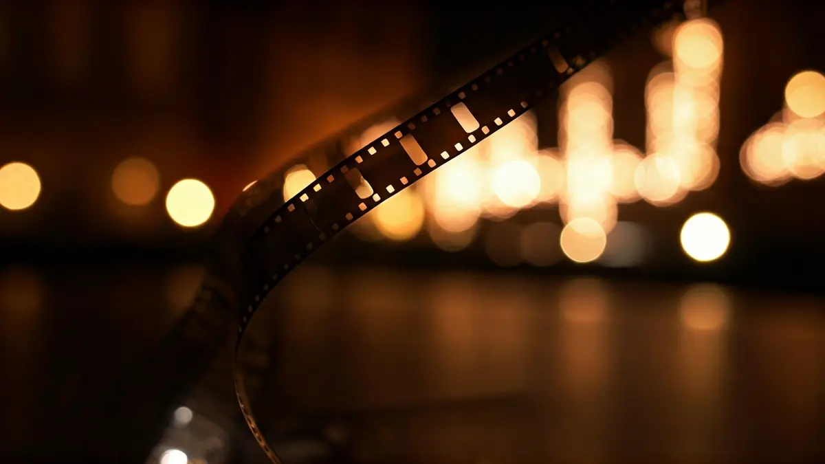 Generic image of a film reel with blurred cinematic lights.