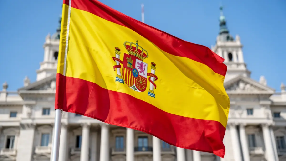 Spanish flag waving in front of the Palacio de Cibeles in Madrid.