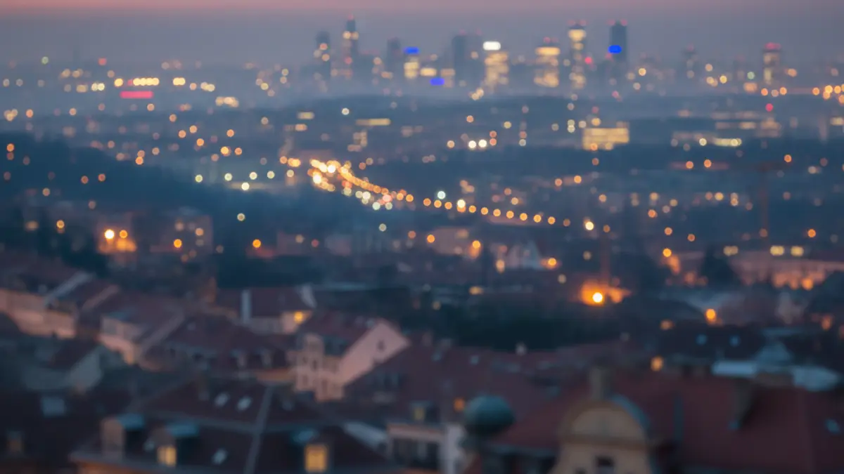 Generic image of an urban landscape at dusk, with city lights and building silhouettes.