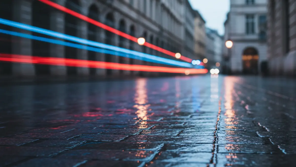 Generic image of police emergency lights reflecting on wet asphalt in a European city.