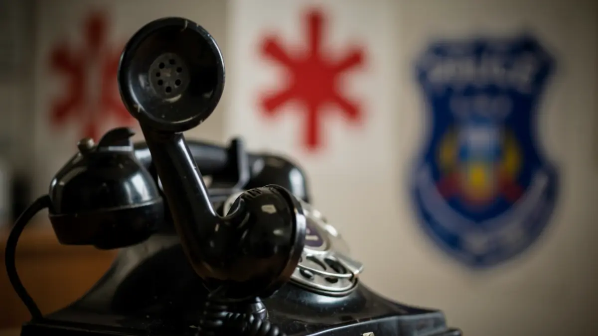 Generic image of an old telephone with emergency symbols.