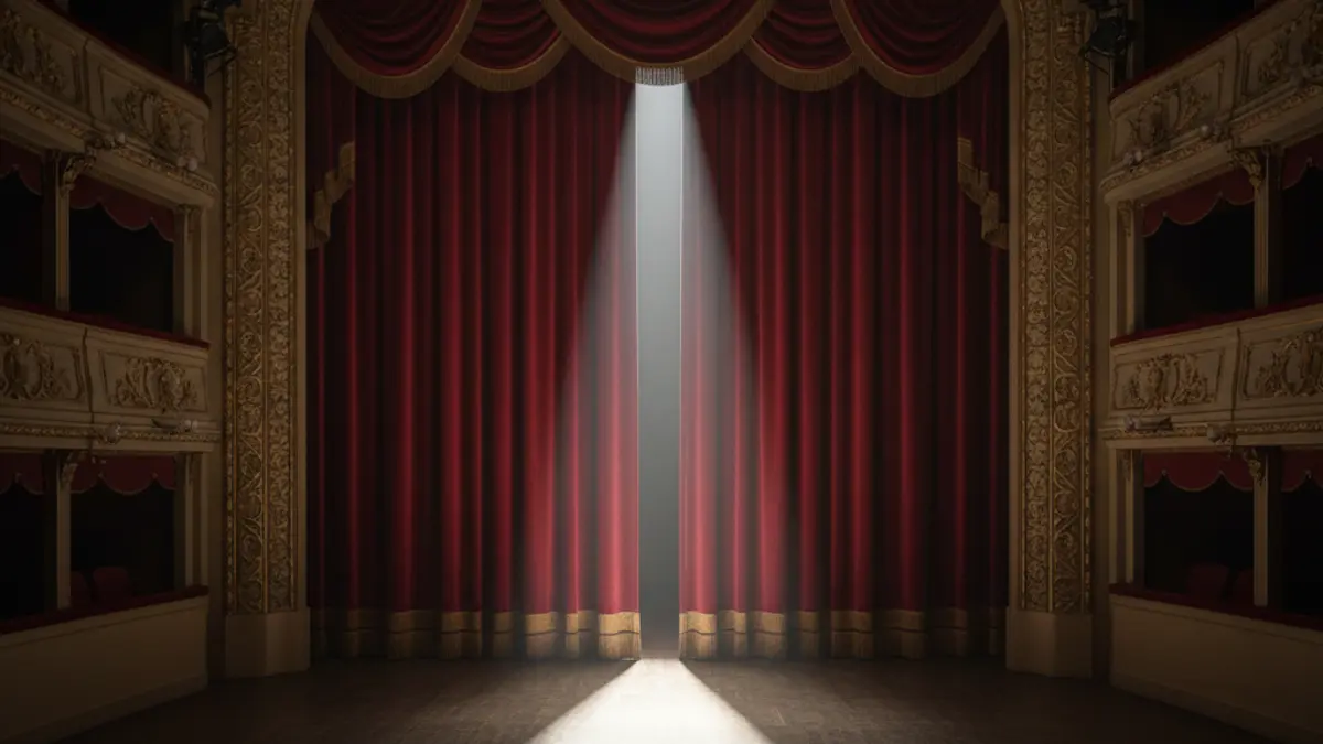 Generic image of an empty theater stage with red curtains.