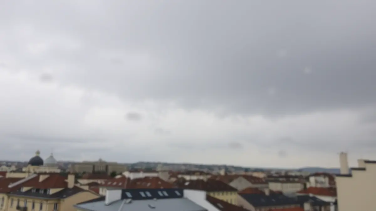 Generic image of an overcast sky with a chance of rain over a city.