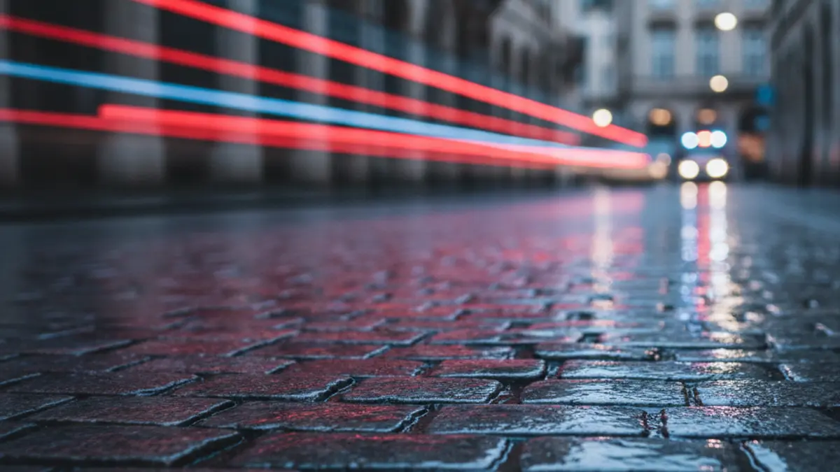 Generic image of emergency lights reflecting on wet asphalt at night.