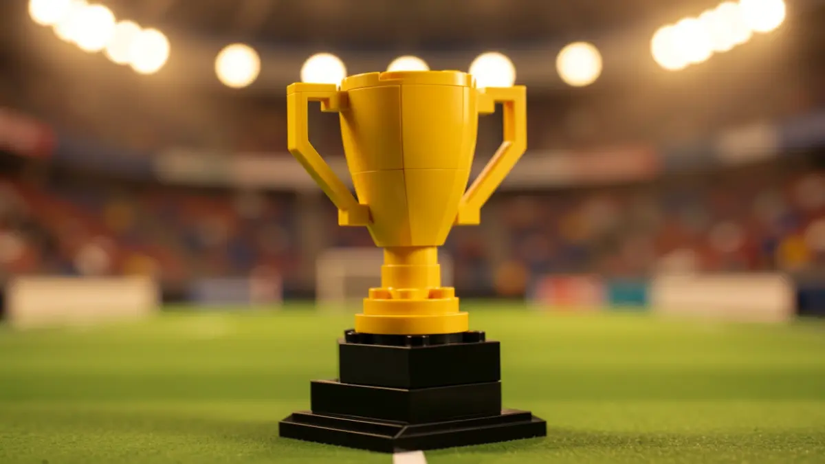 Réplica de trofeo de LEGO con fondo de estadio de fútbol desenfocado.