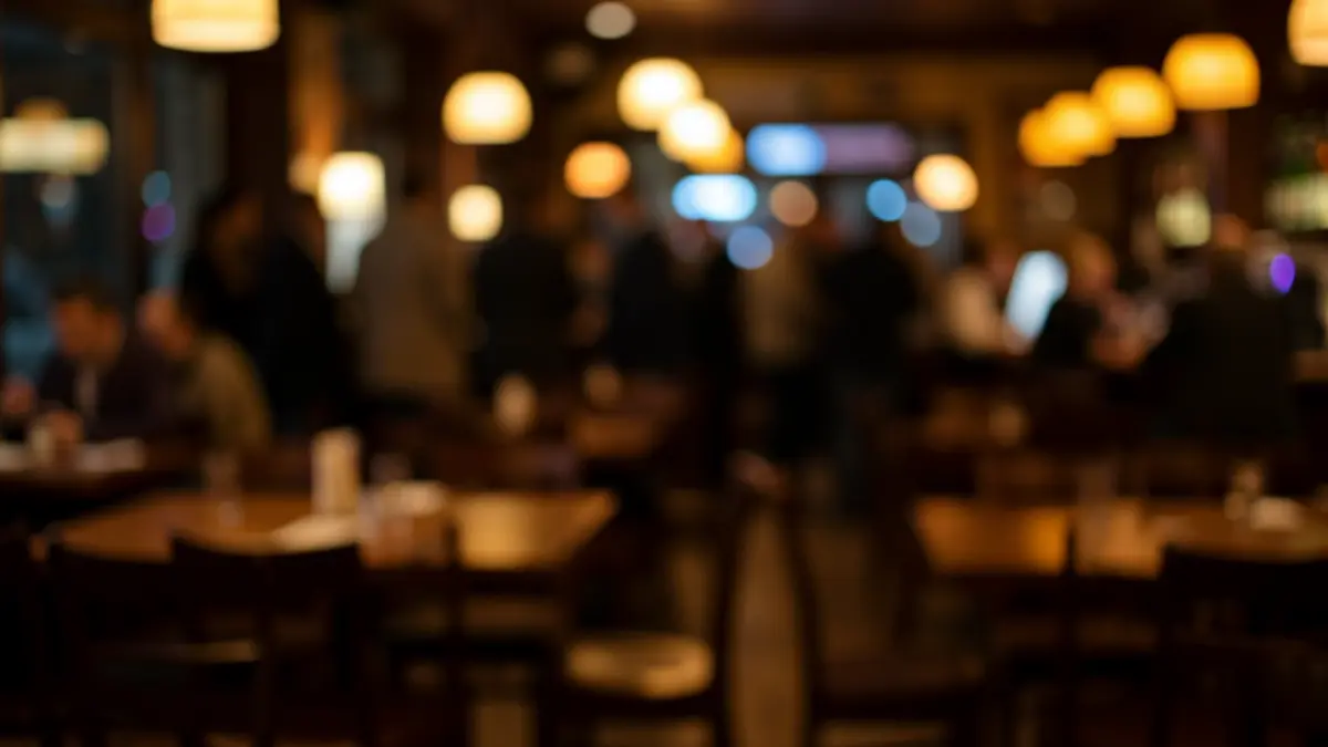 Generic image of a bar interior with dim lights and scattered furniture.