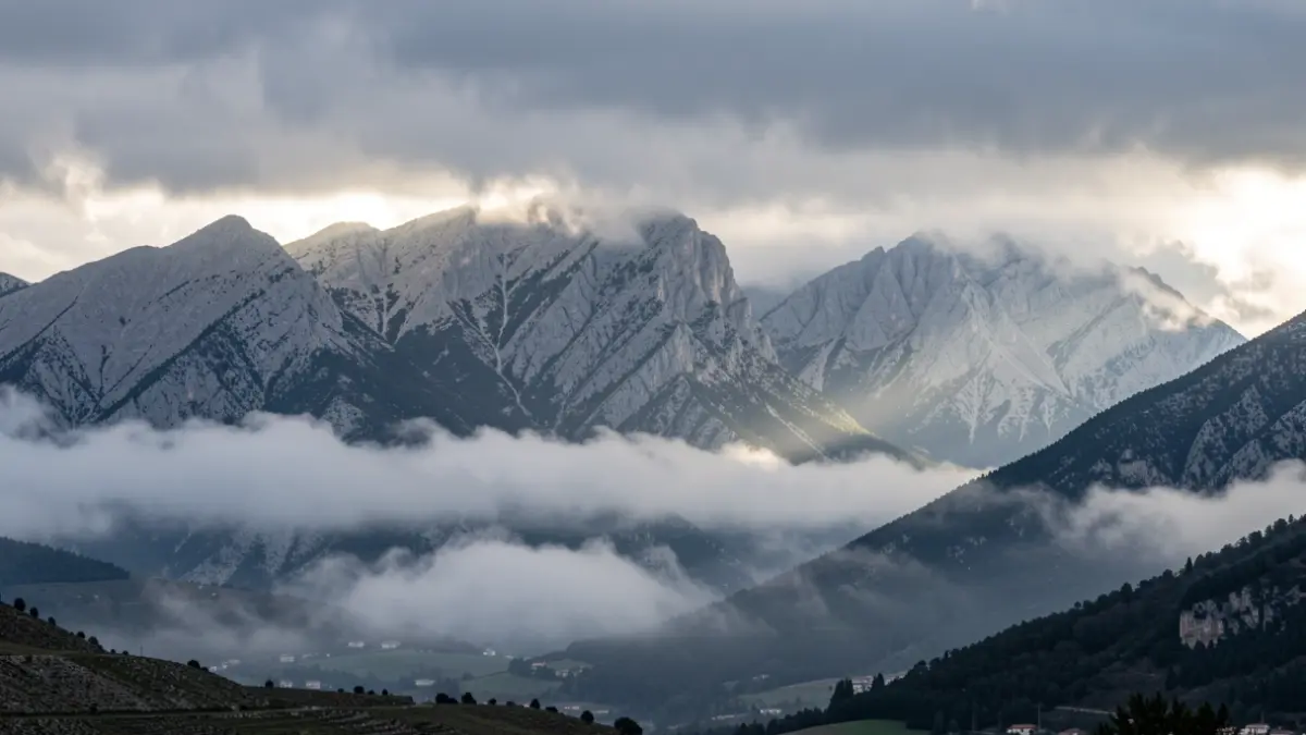 Cloudy sky over the Sierra de Guadarrama with fog in the valleys.