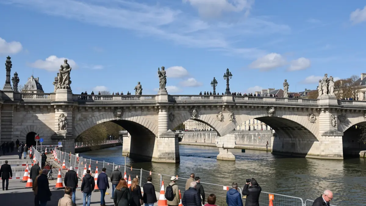 Generic image of roadworks on a historic bridge with regulated traffic.